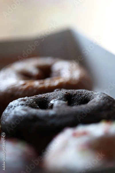 Fototapeta A top down view of multiple donuts.