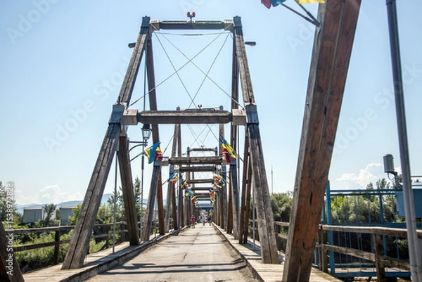 Fototapeta Architectural view of the Solotvyno Friendship Bridge, a vital link across the Tysa River, connecting Ukraine and Romania, a symbol of cross-border connection