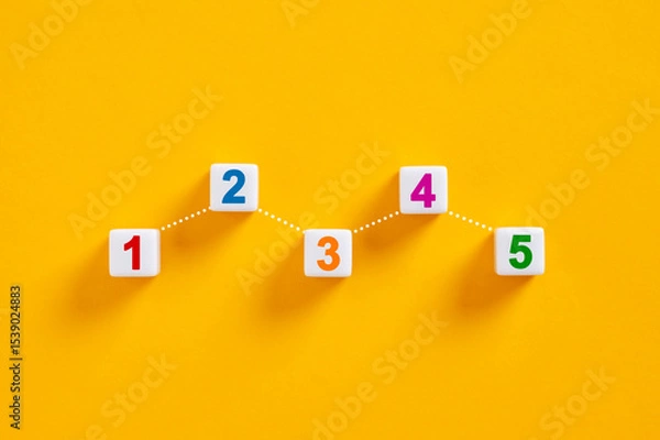 Obraz Numbered cubes forming increasing chart on yellow background