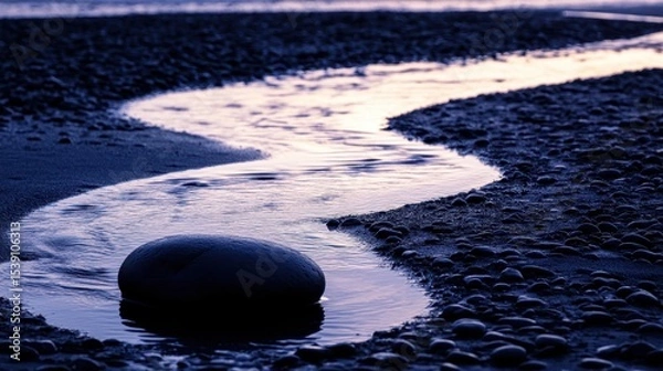 Fototapeta Tranquil Stream Flowing Over Pebbles at Sunset with Soft Light