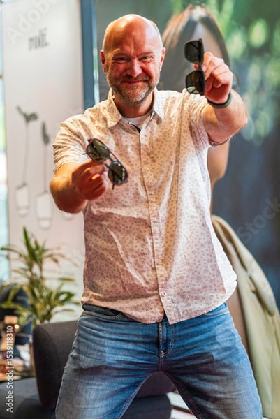 Obraz Happy man with bald head and sun glasses at shop 