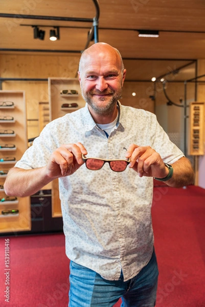 Obraz Happy man with bald head and sun glasses at shop 
