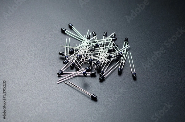 Fototapeta Black infrared photodiodes arranged on dark background for electronics use
