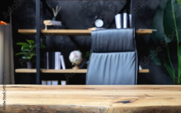Fototapeta Modern business office with leather chair and wooden desk in front of elegant bookshelf with decor and books. Workspace interior for executive or entrepreneur