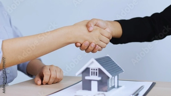 Fototapeta Real men in suits finalize a business agreement with a firm handshake, symbolizing partnership and success