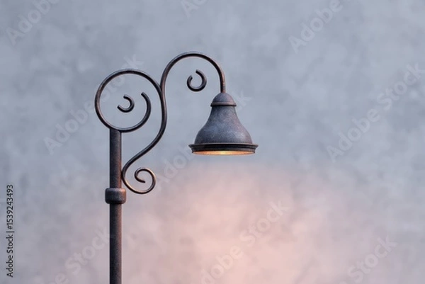 Fototapeta Vintage street lamp illuminates area. Old lamp post, classic style, warm light glow.
