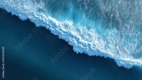 Fototapeta Ocean wave crashes dramatically from aerial perspective. Marine environment, sea foam, oceanography, splash, surge, aquamarine