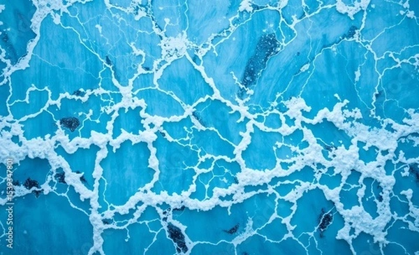 Fototapeta A captivating blue marble texture adorned with the dynamic waves of a sea forms the backdrop of a mesmerizing natural wonder The metamorphic rock composed of calcite with a crystalline surface reveals