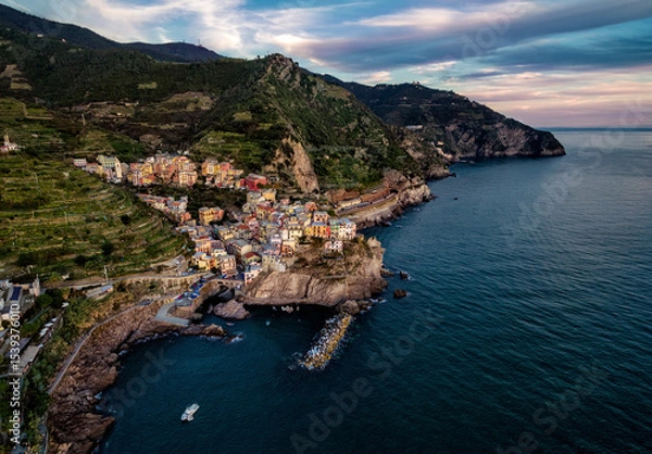 Obraz Aerial view of coastal village nestled between mountains and the sea under a cloudy sky in italy