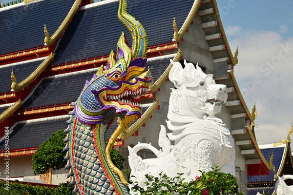 Obraz Statues of Naga and Singha, which are animals in Thai art, decorate the front of the ordination hall and chapel at Wat Den Sali Si Mueang Kaen temple. Located at Cheng Mai Province in Thailand.