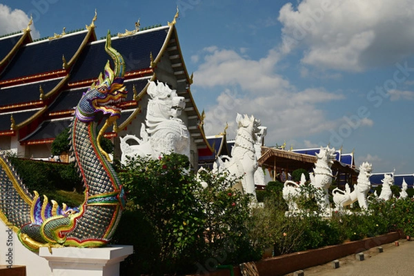 Obraz Statues of Naga and Singha, which are animals in Thai art, decorate the front of the ordination hall and chapel at Wat Den Sali Si Mueang Kaen temple. Located at Cheng Mai Province in Thailand.