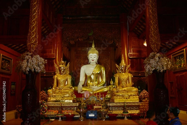 Obraz The statue of Phra Chao Tan Jai Buddha is enshrined in a teakwood chapel at Wat Den Sali Si Mueang Kaen temple or Wat Ban Den. Located at Cheng Mai Province in Thailand.