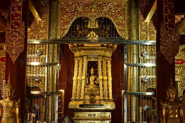 Obraz The statue of Phra Chao Pantan Buddha is enshrined in a teakwood chapel at Wat Den Sali Si Mueang Kaen temple or Wat Ban Den. Located at Cheng Mai Province in Thailand.