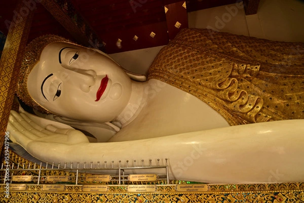 Obraz The Reclining white statue Phra Chaeo Nip Phran Buddha is enshrined in a teakwood chapel at Wat Den Sali Si Mueang Kaen temple or Wat Ban Den. Located at Cheng Mai Province in Thailand.