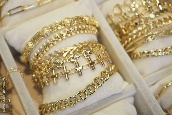 Fototapeta Elegant gold bracelets displayed in a jewelry showcase