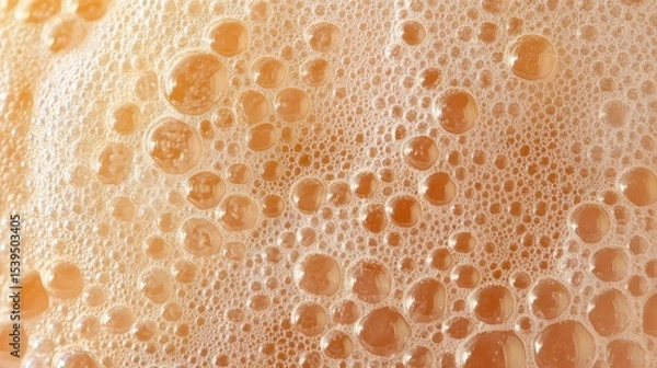 Fototapeta Close-up of orange liquid with many bubbles, foam texture background.