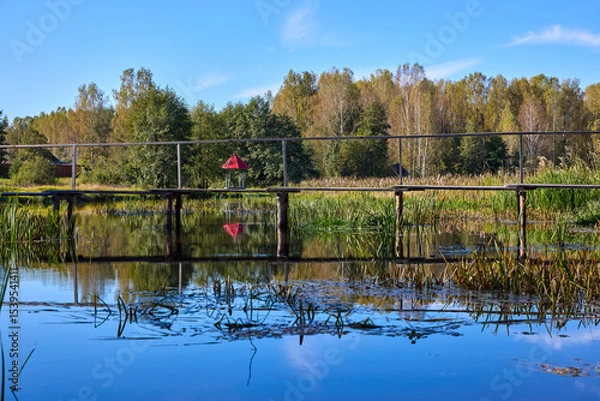 Obraz Serene Forest Lake with Wooden Bridge Reflection