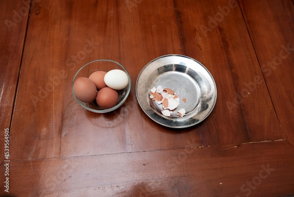 Obraz Bowl containing chicken boiled egg and skin egg on plate in the kitchen table, prepares breakfast at home, health care and food concept. Copy space