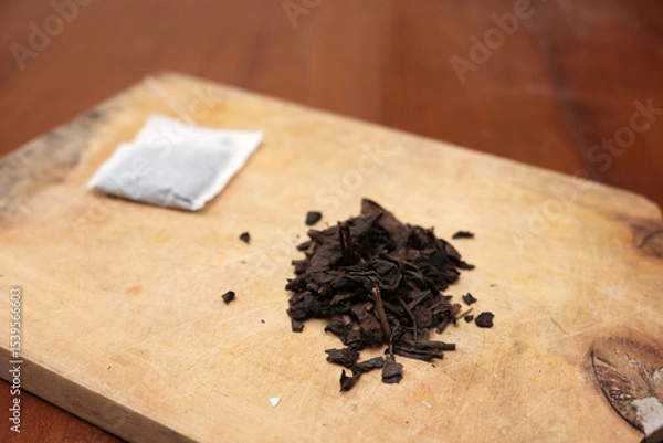 Obraz Tea bags and a bunch of loose tea in the wooden board. A quick and convenient way to brew tea.