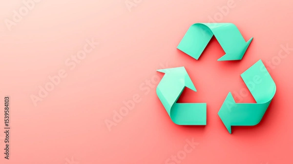 Fototapeta A turquoise recycling symbol made of folded arrows is displayed on a soft pink background, symbolizing sustainability and environmental awareness.