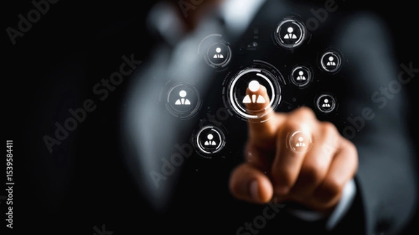 Fototapeta A hand in a business suit interacts with virtual icons representing people, symbolizing digital networking and human resources technology.
