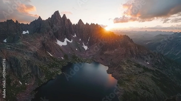 Obraz Sunset Over Jagged Mountain Peaks and Reflective Alpine Lake