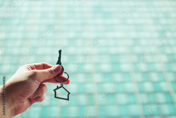 Fototapeta House model and key in home insurance broker agent ‘s hand or in salesman person. Real estate agent offer house, property insurance and security, affordable housing concepts