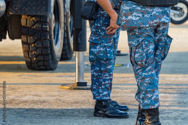Obraz Soldiers in military uniforms wear military combat boots.