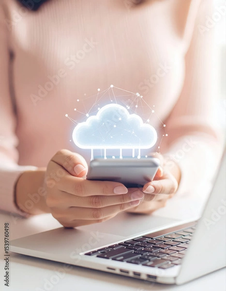 Obraz Photography of a person using the phone and labtop with cloud icon on the screen.
