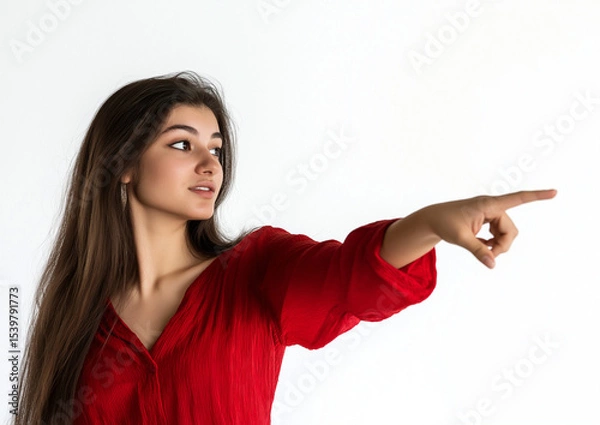 Fototapeta Young Woman in Red Shirt Pointing at Empty Space – High-Quality Stock Photo with Professional Color Grading, Minimal Contrast, and Clean, Sharp Focus on White Background