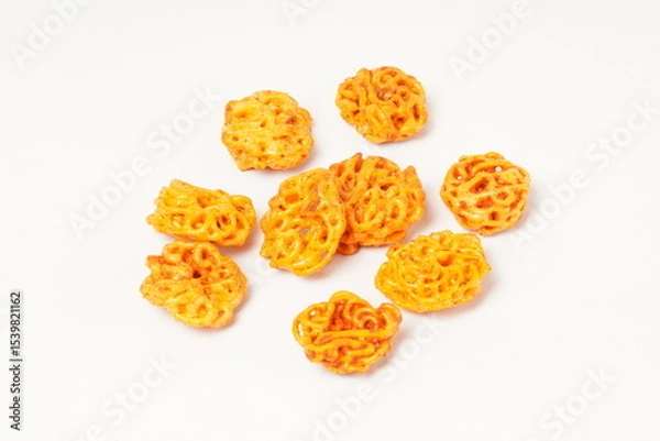 Fototapeta A pile of spicy Indonesian crackers or Kerupuk with spiral twists, coated in red-orange chili powder and rich spices. Bold, flavorful, and appetite-boosting. Photographed against a white background.