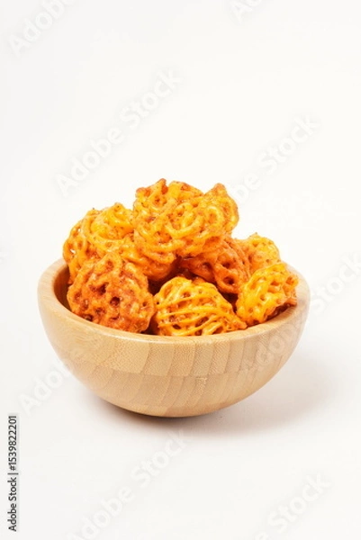 Fototapeta A pile of spicy Indonesian crackers or Kerupuk with spiral twists, coated in red-orange chili powder and rich spices. Bold, flavorful, and appetite-boosting. Photographed against a white background.