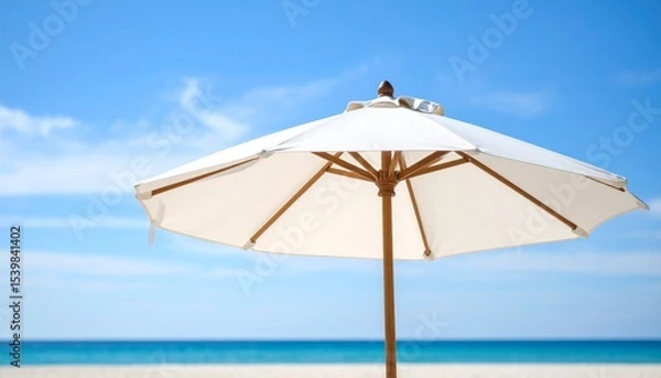 Fototapeta Relax under a vibrant beach umbrella on the sunny sand with a clear blue sky, overlooking the tropical ocean