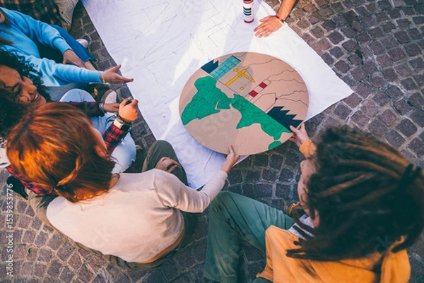 Fototapeta Students designing a model of earth pollution for environmental project