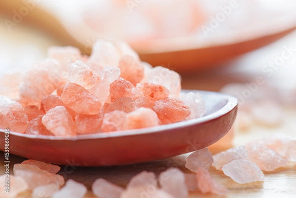 Fototapeta Closeup view of wooden spoons with Himalayan salt crystals