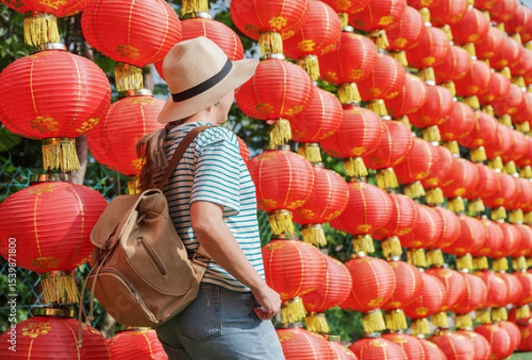 Fototapeta Female tourist enjoying view of traditional Chinese red lanterns