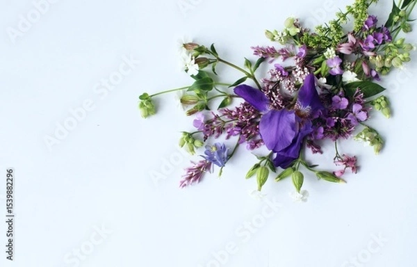 Fototapeta A summer bouquet with an iris in lilac tones.  A flower arrangement with a place for text.