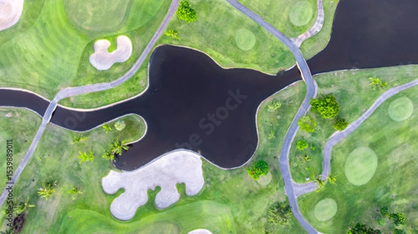 Fototapeta Aerial top view golf course with lush greens, green fairway and sand bunker, Golf course green grass and trees fairway and putting green, Beautiful golf course.