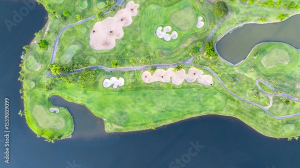 Fototapeta Aerial top view golf course with lush greens, green fairway and sand bunker, Golf course green grass and trees fairway and putting green, Beautiful golf course.