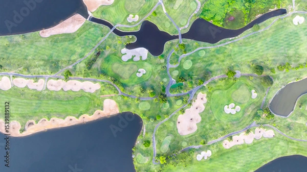 Fototapeta Aerial top view golf course with lush greens, green fairway and sand bunker, Golf course green grass and trees fairway and putting green, Beautiful golf course.