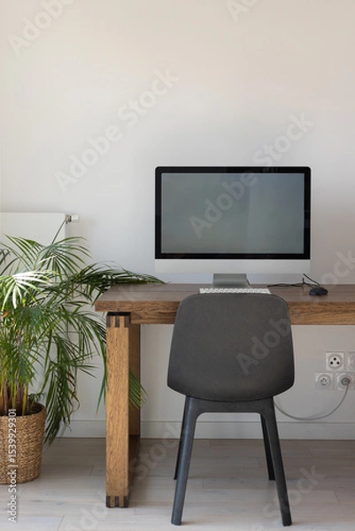 Fototapeta modern bright workplace with desktop computer on wooden table, office workplace with white wall, vertical with copyspace