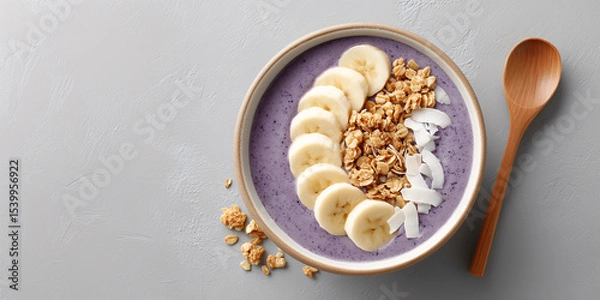 Fototapeta Healthy Breakfast Delight: A colorful, top-down shot showcases a healthy breakfast bowl. Fresh banana slices, granola clusters.