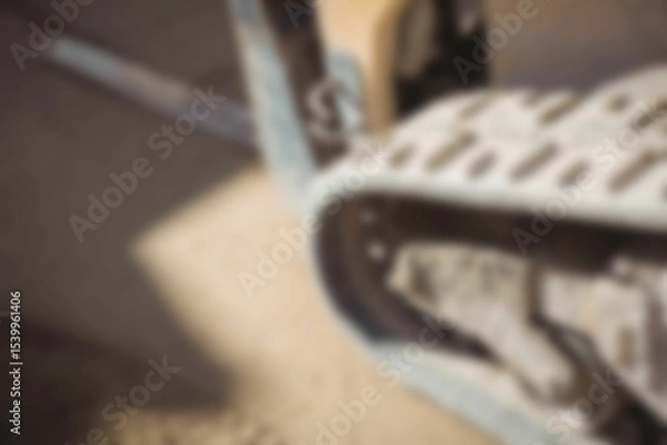 Fototapeta Defocussed image of forklift truck caterpillar tyre track, with copy space
