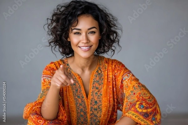 Fototapeta Smiling young woman pointing finger and choosing you