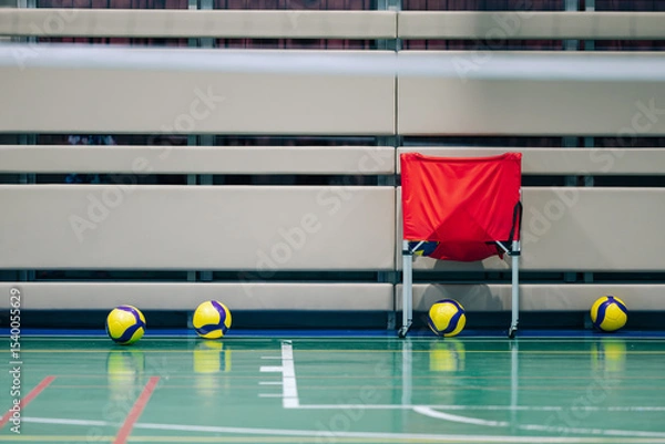 Obraz Volleyball and ball cart on court floor with padded wall background in sports facility