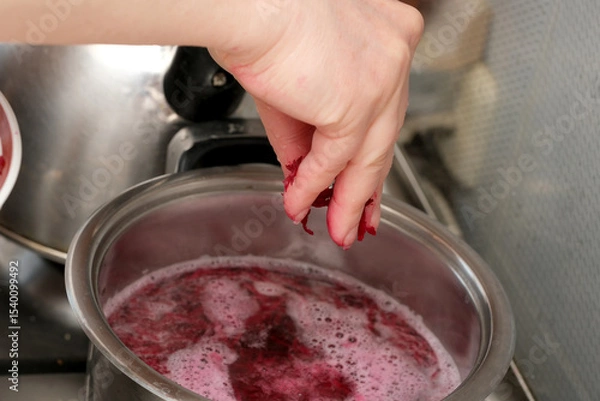 Obraz Creating vibrant homemade jam in a cozy kitchen setting