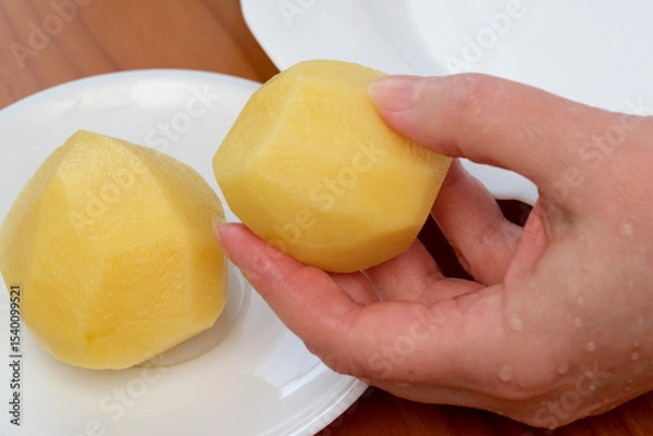 Obraz Shaped and peeled yellow potatoes ready for culinary creativity