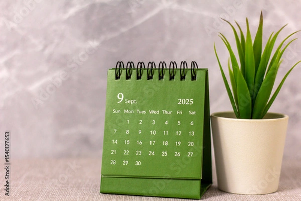 Fototapeta Hello, September 2025. Desktop calendar for planning on a gray background.