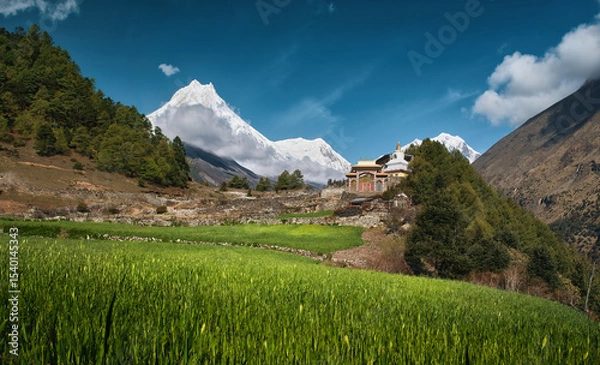 Fototapeta Scenic landscape with ancient temple against backdrop of Mount Manaslu, part of Mansiri Himal, Nepal.