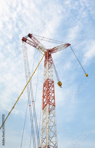 Fototapeta Crane boom. Part of big crane, crawler crane or derrick crane. Machine equipment with hoist, hook and steel truss structure for heavy load lifting in construction industry and assembly work.